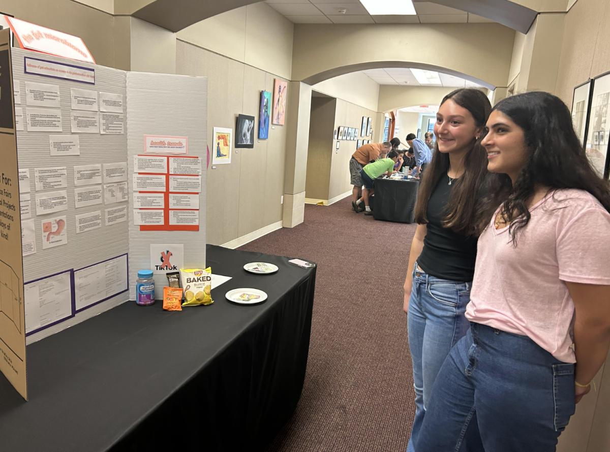 Freshmen Emaan Yousuf and Morgan Aaron present their projects about the gut microbiome at the annual Science Symposium.